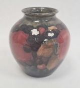 Moorcroft pottery small vase, ovoid and decorated in pomegranate pattern, on a blue ground,