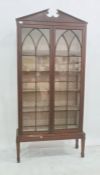 Mahogany glazed display case with broken arch pediment, the two glazed doors enclosing five