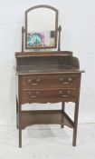 Early 20th century mahogany narrow dressing table, the arched top swing mirror above shelf,