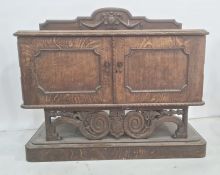 20th century oak sideboard, the rectangular top with rounded front corners, moulded and carved edge,