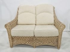 Modern conservatory-type sofa with wicker frame with cream-coloured cushions Condition