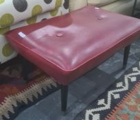 1970's red footstool on tapering supports