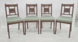 Four Edwardian oak dining chairs, the bar backs and central panel decorated with circular and reeded