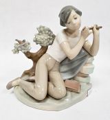 Lladro porcelain figure of boy with flute, 20cm high and another of girl seated with lamb (2)