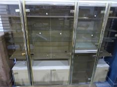 Vintage gilt and smoky glass room unit with an arrangement of cupboards and shelves in four