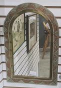 Metal wall mirror of rectangular form with arched top, the frame with tri-colour copper, brass and