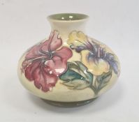 Moorcroft pottery vase of squat baluster form, tube-lined floral decoration on a yellow and green