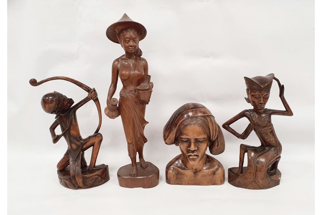 Assorted 20th century Eastern carved figures to include figure in hat carrying jug and basket, - Image 1 of 9