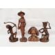 Assorted 20th century Eastern carved figures to include figure in hat carrying jug and basket, - Image 1 of 9