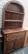 Reproduction oak dresser by M&T Limited, London, with arched plate rack, over a base fitted with two
