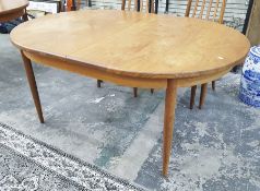 1970's G-Plan style teak extending dining table of oval form on tapering circular supports, 112 x