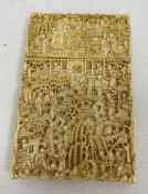 A 19th century Chinese Canton carved ivory card case, relief of figures amongst buildings and trees,