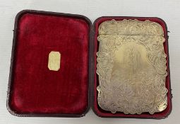 A Victorian silver card case, engraved decoration of scrolls surrounding putti, waterfall and