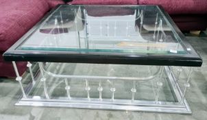 Square glass-topped coffee table on polished metal club fender-type base