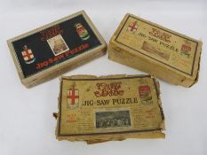 Three boxes of wooden jigsaw puzzles and a lace tray cloth