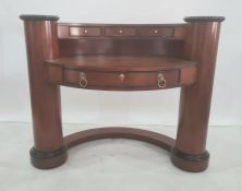 Modern dressing table of curved form, with three short drawers above the bowfront, the top above