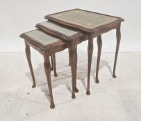 Nest of three 20th century mahogany and leather-topped coffee tables