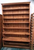 Large pine waterfall bookcase of seven shelves, moulded cornice, plinth base, 140cm x 223cm