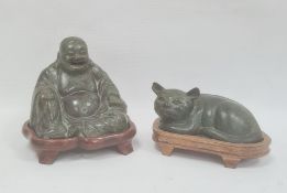 Bronze effect seated buddha on stand and similar lying cat, green patinated finish