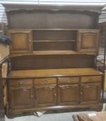 20th century dresser, the moulded cornice above assorted open shelves, cupboard doors, the base of