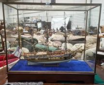 Painted wooden model of The Royal Yacht Caroline 1749, in glazed and stained wood table-top cabinet,