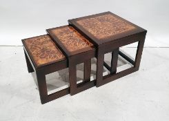 Mid-century nest of three tables with tile tops, flowerhead design to the centre