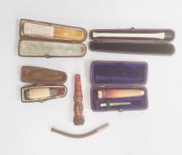 Five various meerschaum and amber cheroot and cigar holders, four cased, with various decoration (5)