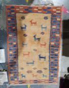 Modern Eastern-style rug, yellow ground decorated with animals, in peach and blue border, 144cm x
