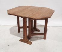 Oak Cotswold School-style gateleg coffee table with octagonal cross-cut oak top (when extended) on