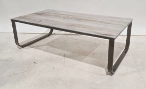 Glass-topped rectangular coffee table on black metal base, 104.5cm wide
