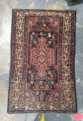Eastern rug, dark blue ground with central peach ground medallion, foliate decorated field, multi-