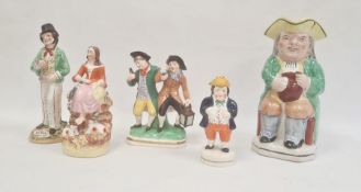 Collection of Staffordshire pottery figures, circa 1880, including a Toby jug, 24cm high overall,