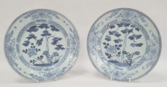 Pair of Chinese export blue and white plates, 18th century, painted with flowering trees and