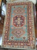 Modern Eastern-style rug, green ground with three central hooked medallions, stepped border, 145cm x