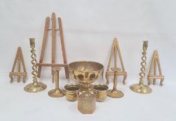 Pair of brass candlesticks, each with open spirally turned column, another pair of candlesticks,