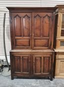 Georgian oak cupboard, the moulded cornice above panelled doors enclosing shelves, the base of two