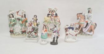 Six Staffordshire pottery figures and a continental porcelain figure, mid to late 19th century,