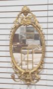 Possibly late 19th century girandole wall mirror, the oval glass plate in moulded frame with two