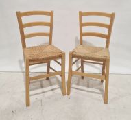 Four 20th century beech framed wicker seated chairs and a linen basket (5)