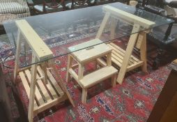 Modern glass topped table on adjustable work bench type bases together with kitchen steps (2)