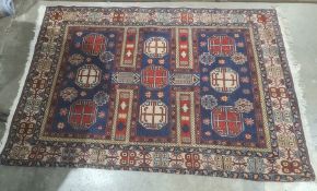 Modern Eastern-style blue ground rug in blues, reds, creams and yellows, 196cm x 135cm