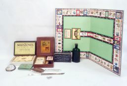 Milestones Game of Life, a vintage Gordons gin bottle, Rhodian cigarette tin, pair of servers and