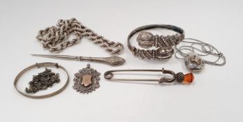 Modern silver pendant of teardrop design on snake-link chain, an engraved child's bangle, a