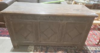 Possibly 18th century and later oak coffer, the rectangular top with moulded edge, three carved