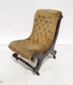 Late Victorian low chair in olive green button upholstery, black ebonised frame, raised on black