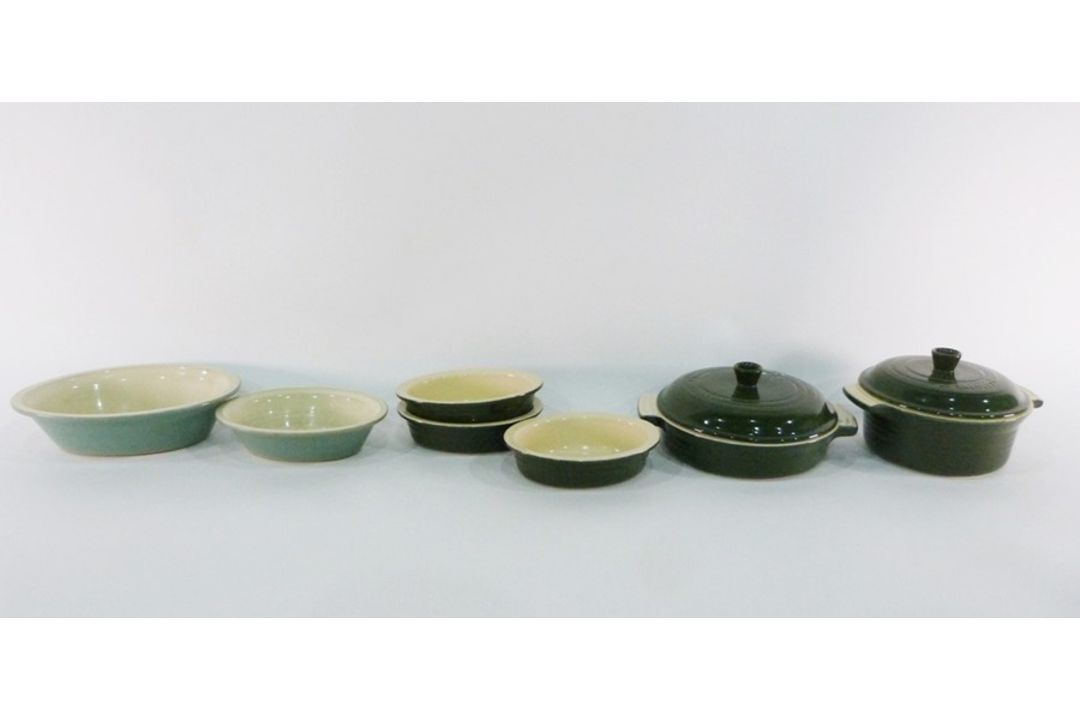 Collection of green and cream Le Creuset ceramic (stoneware) cookware including two lidded