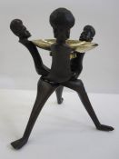 Carved hardwood stand of three warriors with brass bowl, possibly used for fruit, 32cm high