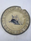 A Delft blue and white plate with alphabet rim, decorated with kitten at table drinking milk from