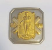 Cricket interest: Embossed and partly gilt metal buckle with batsman, wickets and pair crossed bats,