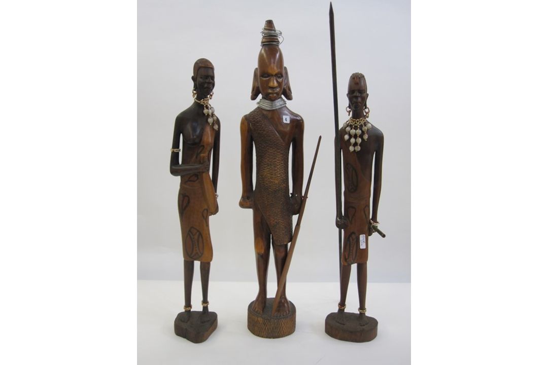 Carved Tanzanian warrior with spear, 54cm high and a pair of male and female Tanzanian figures